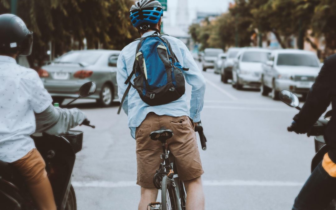 Man rides a bike with a backpack and helmet on (1)